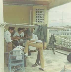 Philipino band practicing on rooftop of hotel across the alley